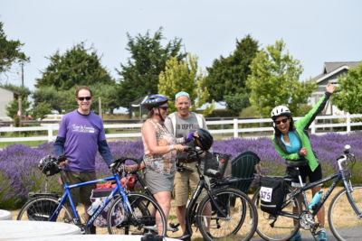 Happy riders relaxing off their bikes at a rest stop